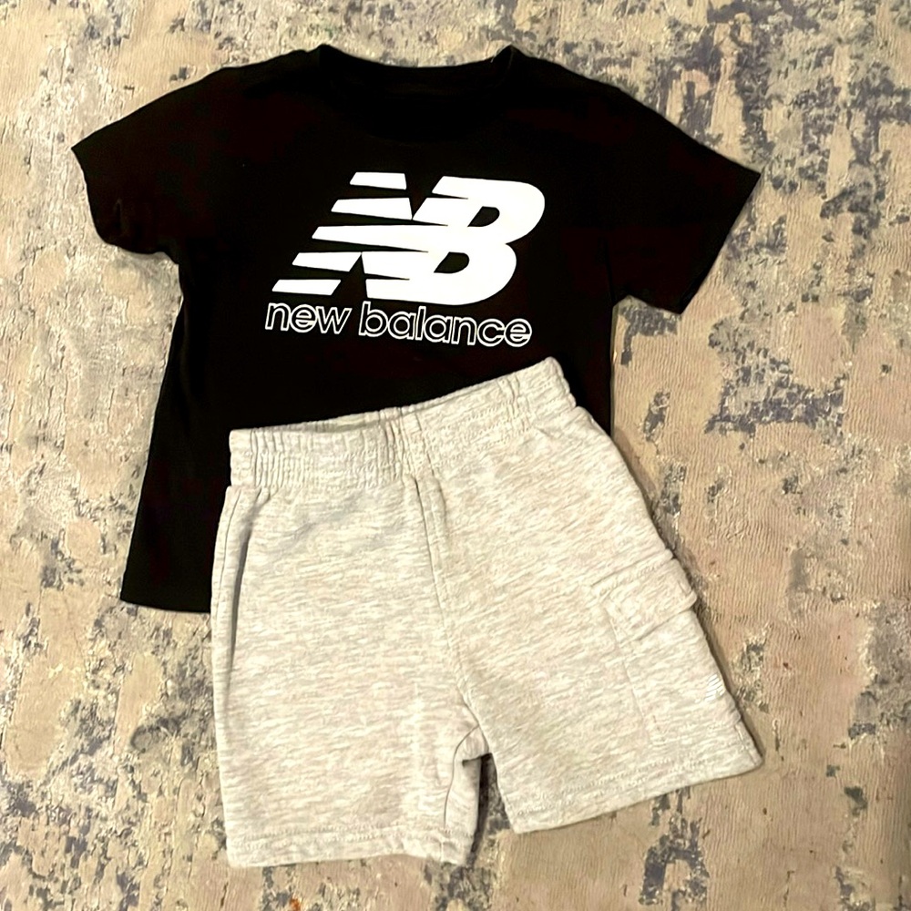 New balance set of short sleeve black shirt and grey shorts. Size 24 months.